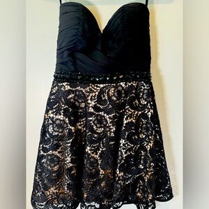 Black strapless mini dress with lace and rhinestone bang around the waist.